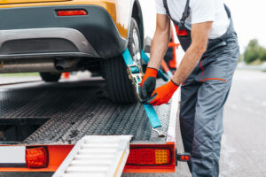 Tow truck driver preps vehicle to hitch