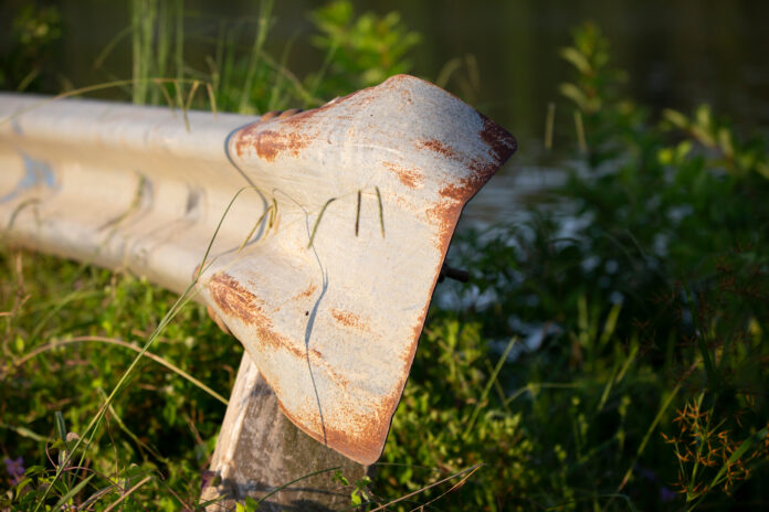 Bent,Metal,Guardrail,In,A,Green,,Grassy,Area bent metal guardrail after DUI accident