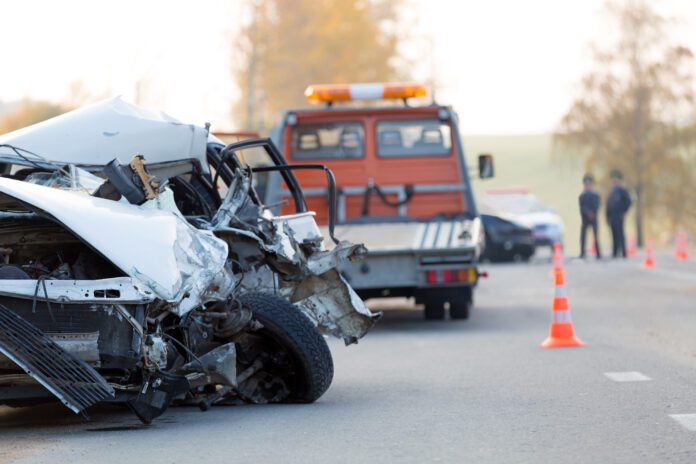Crashed,Car,Automobile,Collision,Accident,With,Police,And,Tow,Truck aftermath of a tow truck accident with fatalities