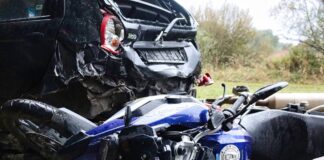 Crashed vehicle and motorcycle along the road following incident