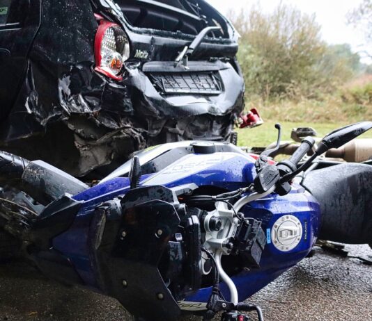 Crashed vehicle and motorcycle along the road following incident