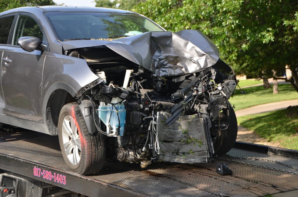 Totaled vehicle being towed away from scene of incident