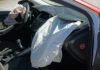 Exposed airbags depicted in vehicle after crash accident