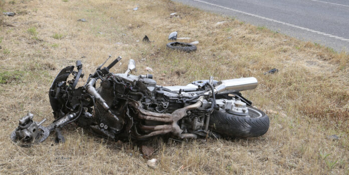 dreamstime_l_118032130 Crashed motorcycle scattered on side of road
