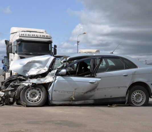 Semi truck altercation with crashed car on freeway