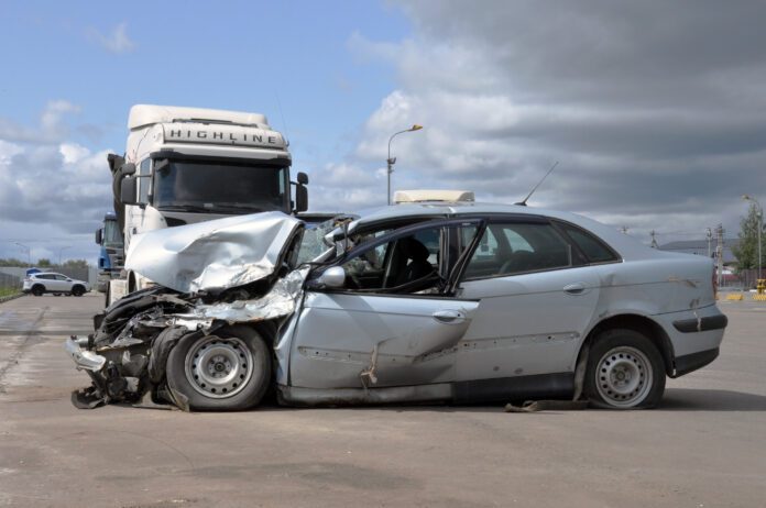 dreamstime_l_155744031 Semi truck altercation with crashed car on freeway