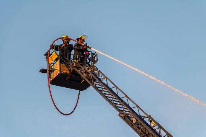 dreamstime_l_187245998 Elevated fire crew extinguishing fire