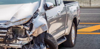 Silver pickup truck severely crashed after accident