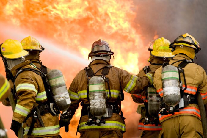 dreamstime_l_2533420 Five firefighters struggle to put out structure fire
