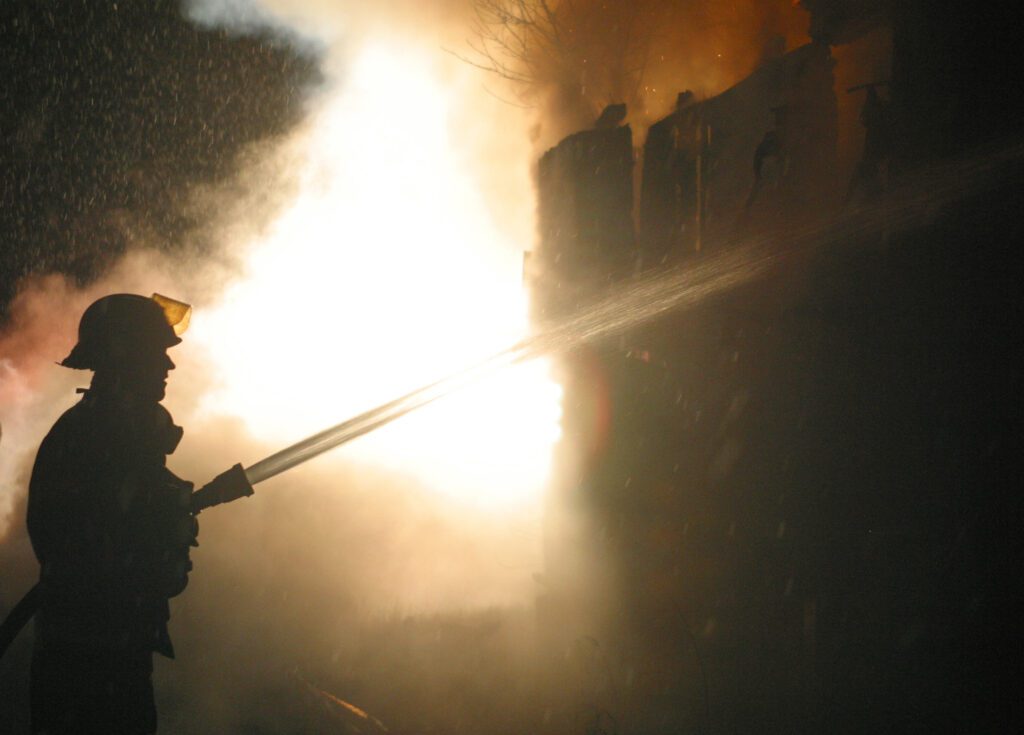 Firefighter extinguishing house fire 