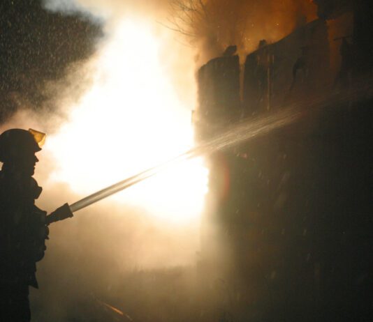 Torrey Pines Garage Fire Burns Through House Firefighter extinguishing house fire