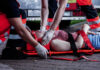 Medic bending over car accident victim