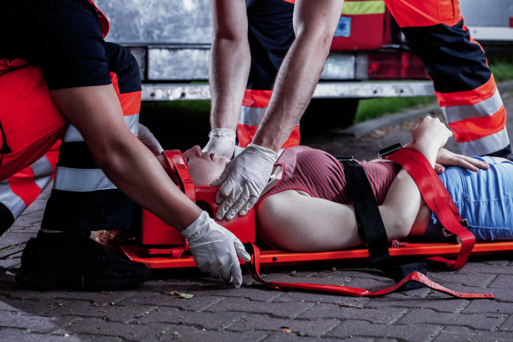 Medic bending over car accident victim 