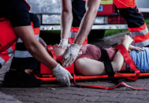 Medic bending over car accident victim