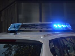 police car flashing sirens at scene of accident