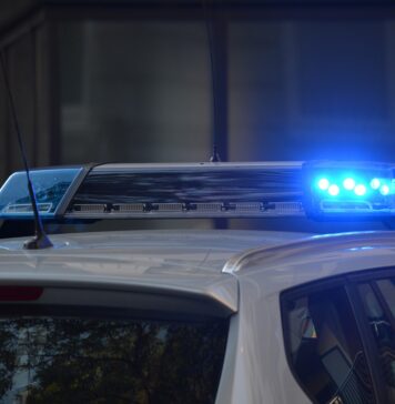 police car flashing sirens at scene of accident