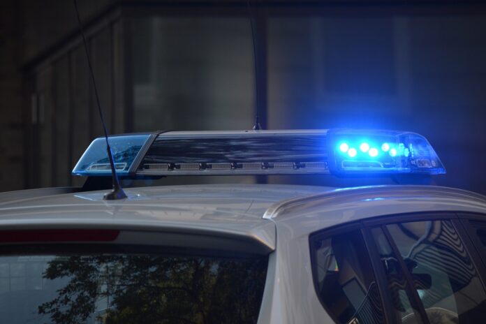 police car flashing sirens at scene of accident