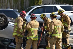 Emergency respondents assist victim stuck in wrecked vehicle