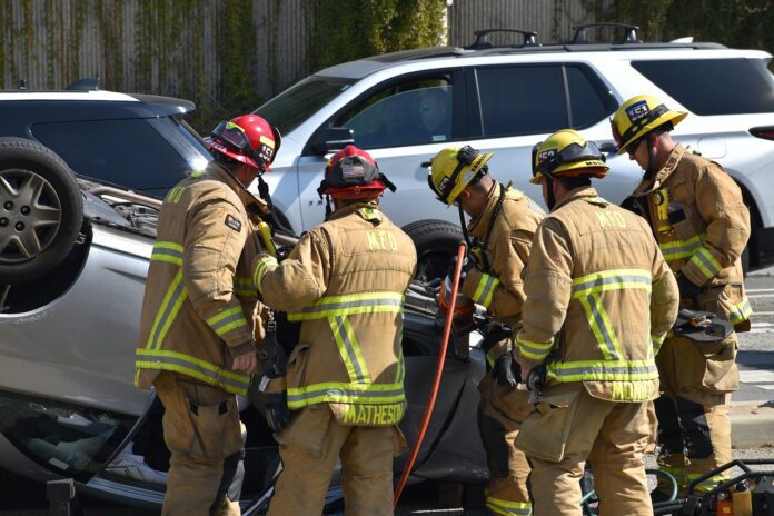 Emergency respondents assist victim stuck in wrecked vehicle