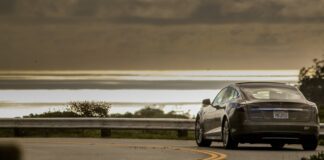 Gray Tesla driving on highway