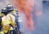 firefighters bracing dangerous house fire in attempt to put it out