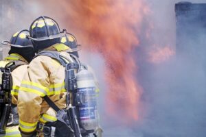 firefighters bracing dangerous house fire in attempt to put it out