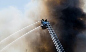 firefighters attempting to put out house fire