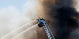 firefighters attempting to put out house fire