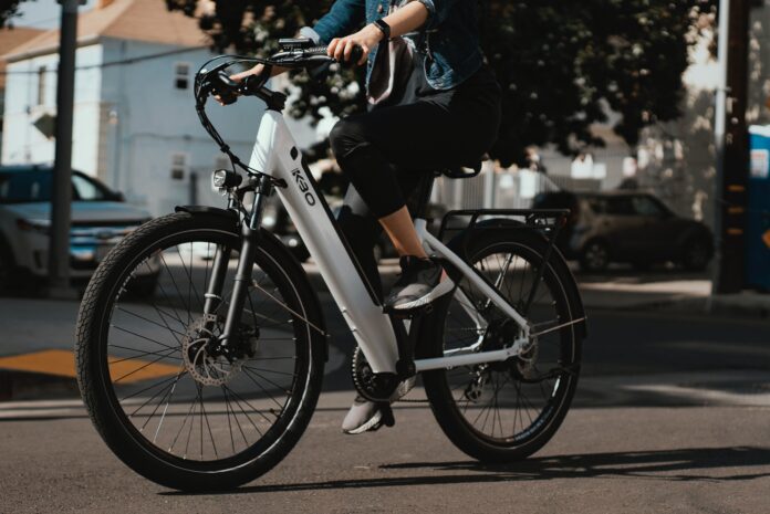 White e-bike depicted on road