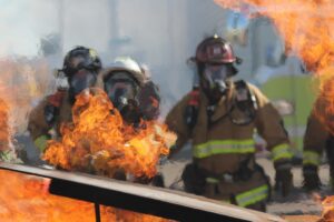 Firefighters attempt to put out vehicle fire in freeway crash