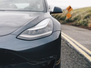 Black Tesla driving on highway