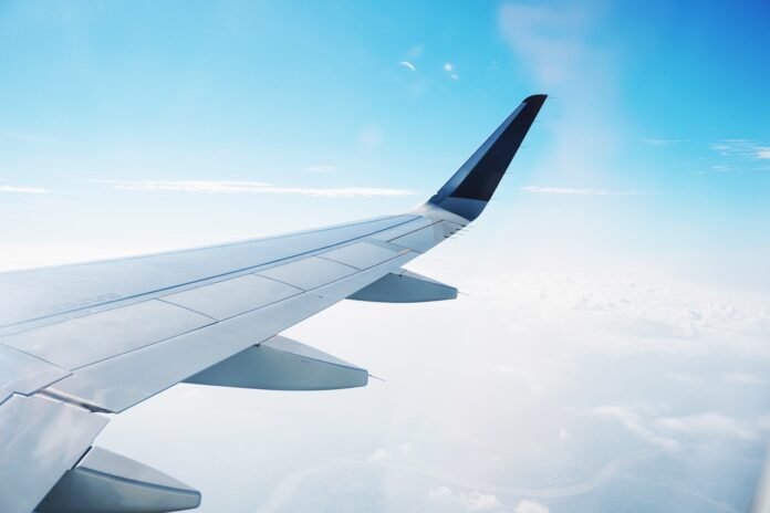 business-jet Wing of business jet depicted while flying in air