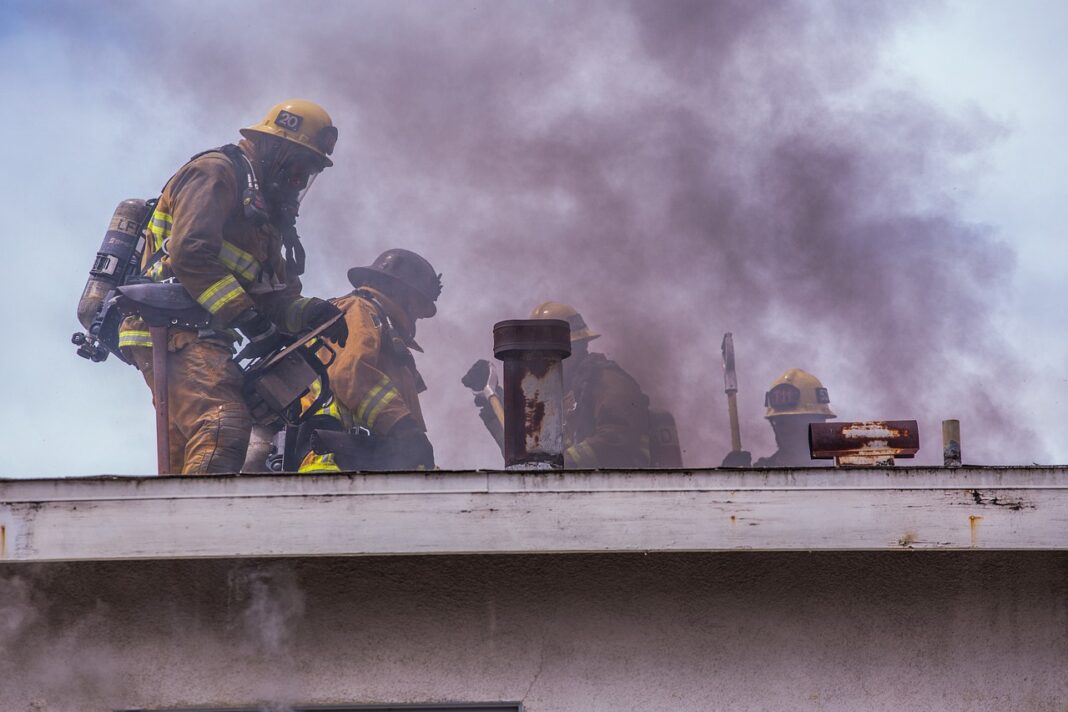 firefighters attempting to put out a large house fire