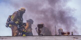firefighters attempting to put out a large house fire
