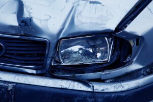 broken headlight depicted after car accident