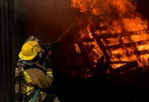 firefighters arrive to scene of house fire and attempt to put out large flames
