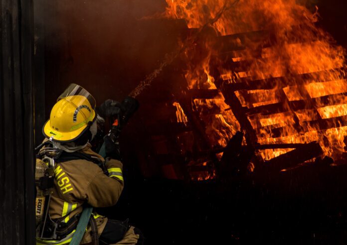 house-fire firefighters arrive to scene of house fire and attempt to put out large flames