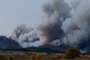 large wildfire smoke clouds depicted in the distance 