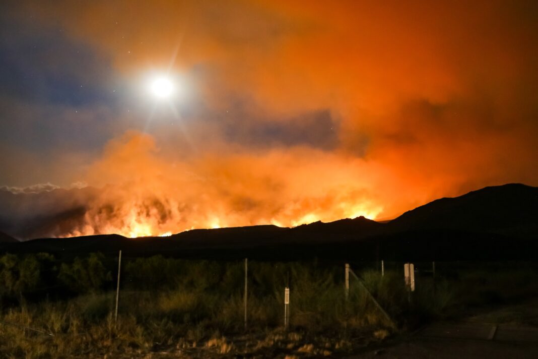 large wildfire blazes through homes and farms