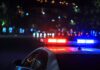 police car depicted arriving at late night car crash
