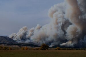 Fire depicted sweeping over terrain 