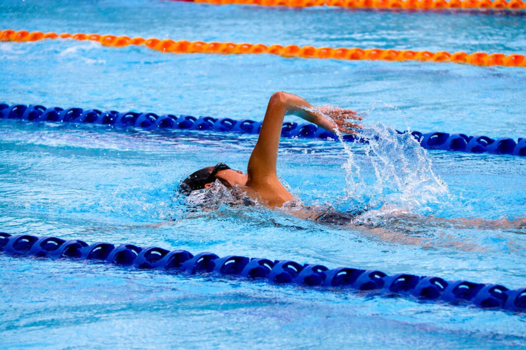 Student swimming in school swimming pool.