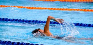 Student swimming in school swimming pool.