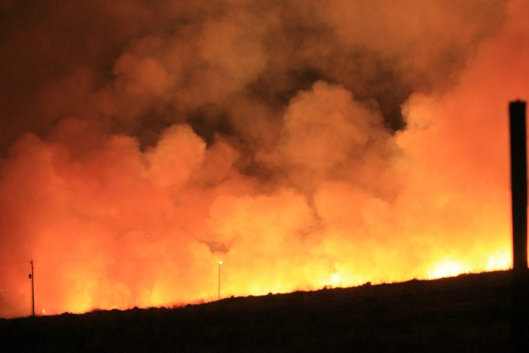 large wildfire and smoke depicted