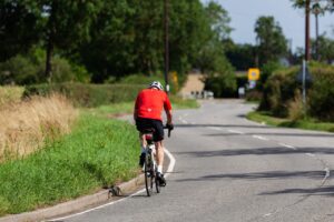 bicyclist depicted riding bicycle on road