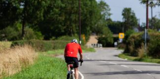 bicyclist depicted riding bicycle on road