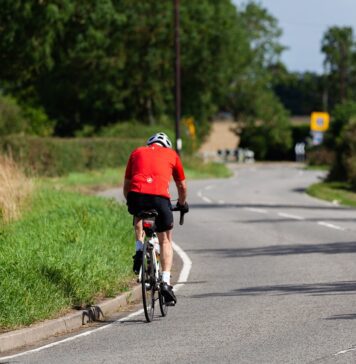 bicyclist depicted riding bicycle on road