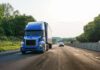semi trailer and vehicles depicted traveling on interstate
