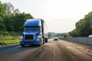 semi trailer and vehicles depicted traveling on interstate