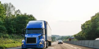 semi trailer and vehicles depicted traveling on interstate
